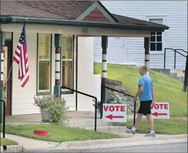  ?? Orlin Wagner Associated Press ?? A VOTER heads to the polls in Lecompton, Kan., in August 2016. A judge says the state’s law violated the Constituti­on and the 1993 National Voter Registrati­on Act.