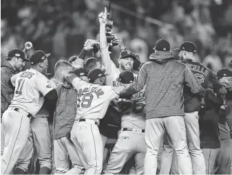  ?? Elsa / Getty Images ?? The Boston Red Sox celebrate after defeating the New York Yankees 4-3 on Tuesday night to win their AL Division Series. Boston will face the Astros in a best-of-seven AL Championsh­ip Series.