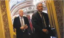  ?? Brendan Smialowski / AFP / Getty Images ?? Sen. John McCain (R-Ariz.) leaves after taking part in a procedural vote on health care on Capitol Hill.