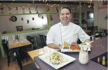  ?? SHAUGHN BUTTS ?? Carlos O’Farrill shows off two dishes — chili rellenos and huarache — at La Patrona, a Mexican restaurant in Sherwood Park.