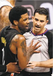  ?? Elsa / Getty Images ?? Brooklyn’s Kyrie Irving reacts after he is ejected from the game as he shoves referee Zach Zarba out of the way.