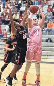  ?? / Danielle Pickett ?? Heritage’s Reagan Armour goes up for two points against Lafayette on Friday night as Marquila Howell tries to defend on the play.