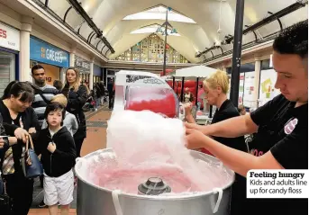  ??  ?? Feeling hungry Kids and adults line up for candy floss