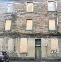  ?? Pictures: Steven Brown. ?? Above: boarded-up properties at North William Street, Perth. Below: a firefighte­r underneath the collapsed ground floor of the Atholl Street property.