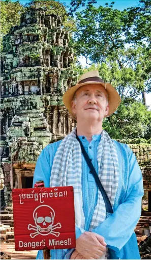  ??  ?? LEGACY OF WAR: Nigel in Cambodia, where mines are a constant danger. Main picture: Temples at Angkor Wat. Top left: A farmer ploughs his field