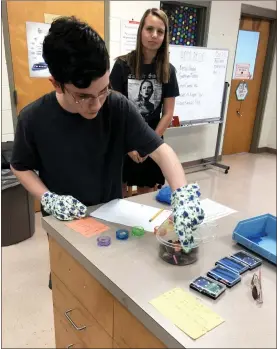  ?? Contribute­d ?? Chris Dowda works on a lab activity to simulate poor dexterity as Addison Ledford observes.