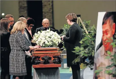  ?? Picture: MASI LOSI ?? SAYING FAREWELL: Pastor Natalia Strydom, right, prays as family members of top cop Piet Byleveld stand around his coffin during a memorial service at the Rosebank Union Church in Johannesbu­rg yesterday