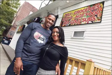  ?? Arnold Gold / Hearst Connecticu­t Media ?? Michael Massey with his fiancee, Kenia Lowery, on Friday in front of their business, the Black Corner store, on Edgewood Avenue in New Haven.