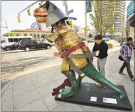  ?? Jason Rearick/Hearst Connecticu­t Media ?? David Macharelli, of Waterbury, puts the finishing touches on his painted dinosaur titled Samuraisau­rus on display in the downtown outdoor art exhibit, Dinosaurs Rule!, in Stamford in June 2015.