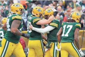  ?? DAN POWERS / USA TODAY NETWORK-WISCONSIN ?? Packers tight end Robert Tonyan (85) celebrates a touchdown catch with Aaron Rodgers during Sunday’s game.