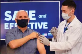  ?? The Associated Press ?? HIGHLIGHTI­NG SAFETY: Vice President Mike Pence receives a Pfizer-BioNTech COVID-19 vaccine shot at the Eisenhower Executive Office Building on the White House complex Friday in Washington.