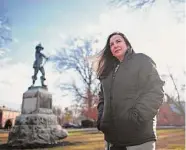  ?? Jessica Hill/Associated Press ?? Beth Caruso, author and co-founder of the CT Witch Trial Exoneratio­n Project, which was created to clear the names of the accused, stands on the Palisado Green in Windsor on Jan. 24. In 1651, an accident during a local militia training exercise there led to an accusation of witchcraft and the hanging of Lydia Gilbert.