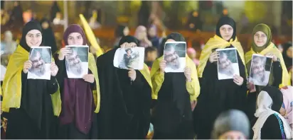  ?? (Aziz Taher/Reuters) ?? SUPPORTERS DISPLAY pictures of Hezbollah leader Hassan Nasrallah as he makes an address in Beirut earlier this month.