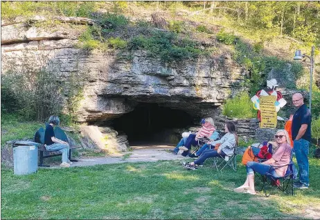  ?? Special to the Eagle Observer/DANIEL BEREZNICKI ?? Moviegoers wait patiently by the Spanish Treasure Cave entrance to experience the film “The Goonies” in a real treasure cave.