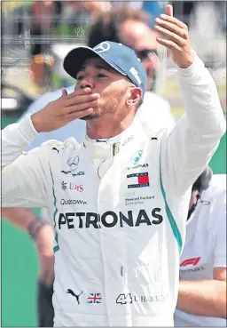  ??  ?? Lewis Hamilton celebrates his Silverston­e pole lap yesterday