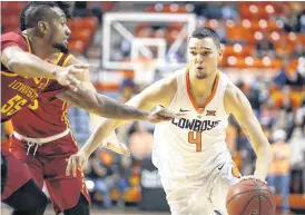  ?? [PHOTO BY BRYAN TERRY, THE OKLAHOMAN ARCHIVES] ?? Oklahoma State’s Thomas Dziagwa, right, goes past Iowa State’s Jeff Beverly during a game in January in Gallagher-Iba Arena.