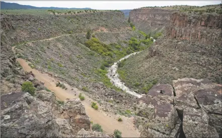  ?? MORGAN TIMMS/Taos News ?? The Slide Trail descends into the Río Grande gorge as seen May 19 in Orilla Verde.