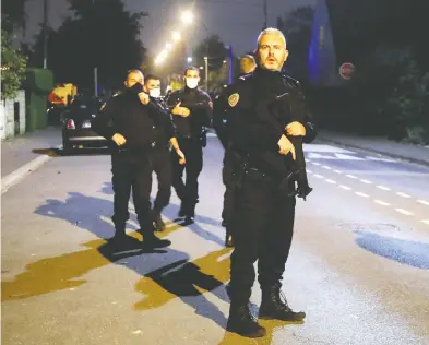  ?? CHARLES PLATIAU/REUTERS ?? Police officers secure the area near the scene of a stabbing attack in the Paris suburb of Conflans St Honorine Friday.