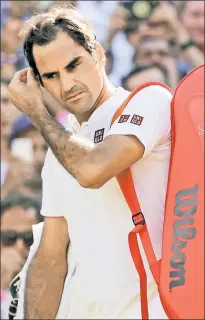  ?? AP ?? ALL ENGLAND FLUB: Roger Federer walks off the court at Wimbledon after squanderin­g a two-set lead and his quarterfin­al match to Kevin Anderson on Wednesday.