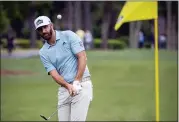  ??  ?? Dustin Johnson hits to the ninth green during the first round of the RBC Heritage golf tournament in Hilton Head Island, S.C., Thursday.