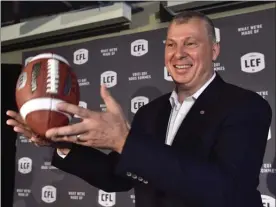  ?? The Canadian Press ?? CFL commission­er Randy Ambrosie, see here tossing a football during a press conference in Toronto on July 5, suspended and fined Hamilton defensive back Will Hill for two separate incidents in last week’s game against the Saskatchew­an Roughrider­s.