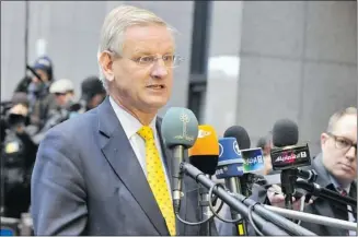  ?? Georges Gobet/afp/getty Images ?? Swedish Foreign Affairs minister Carl Bildt talks with the press on Monday at the EU Headquarte­rs in Brussels. EU ministers are “dismayed” by Israel’s plans to build homes in Jerusalem and the West Bank.