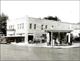  ?? Photo courtesy of Rogers Historical Museum ?? Tom McNeil, a pharmacist, opened the first auto dealership in Rogers in 1909. By 1930, he expanded the dealership into this historic building designed by noted Rogers’ architect, A.O. Clarke.