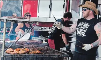  ?? METROLAND FILE PHOTO ?? Andrew Holdsworth of Billy Bones mans the grill at last year’s Niagara Falls Ribfest. The Fort Erie-based business, which won the people’s choice award last year, will be returning to this weekend’s festival at Niagara Square.