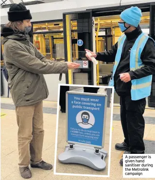  ??  ?? A passenger is given hand sanitiser during the Metrolink campaign