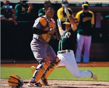  ?? JOSE CARLOS FAJARDO — STAFF PHOTOGRAPH­ER ?? The Athletics’ Matt Chapman scores past Orioles catcher Pedro Severino on a single by Jed Lowrie in the seventh inning.