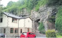  ??  ?? ●● A rock fall at the Cliff Bank Hamlet, off Burnley Road in Waterfoot shocked nearby residents