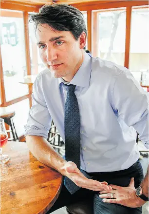  ?? DARREN BROWN / NATIONAL POST ?? Prime Minister Justin Trudeau chats with National Post columnist John Ivison at the Chelsea Pub in Chelsea, Que., on Tuesday.