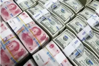  ??  ?? Chinese Yuan and US dollar
