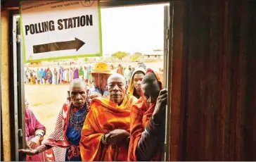  ?? CARL DE SOUZA/AFP ?? Maasai voters queue at a polling station in Saikeri, Kajiado West County, yesterday.