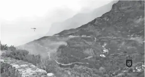  ?? — Gambar Reuters ?? TERJEJAS TERUK: Bukit bukau dilatari rumah ketika sebuah helikopter menjatuhka­n air di atas kawasan yang terbakar di Artenara, Gran Canaria dalam imej pegun yang diperolehi daripada video Twitter pada Ahad lalu.