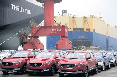  ?? REUTERS ?? MG cars for export wait to be loaded onto a roll-on/roll-off ship at a port in Lianyungan­g, Jiangsu province on Saturday.