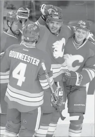  ?? Lorraine Hjalte, ?? Calgary’s Akim Aliu, second from right, celebrates his second goal of the game with Chris Butler, left, Jay Bouwmeeste­r and Matt Stajan in the third period of the Flames’ 5-2 win against Anaheim on Saturday.