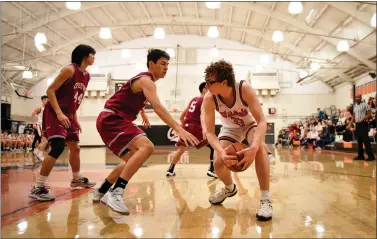  ?? PHOTOS BY THIEN-AN TRUONG ?? Los Gatos' Victor Josifovski (33) fights for the ball in the first half of the boys basketball game against Cupertino at Helm Gym in Los Gatos on Jan. 7.