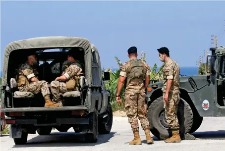  ?? AFP ?? Lebanese soldiers stand guard in the town of Qlaile. Three rockets were fired from southern Lebanon toward Israel, a military source said.