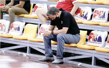  ??  ?? TIM CONE bows his head in disappoint­ment during Barangay Ginebra San Miguel's loss to Alaska. (PBA photo)
