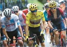  ?? THOMAS SAMSON/AFP-GETTY ?? Tour de France overall leader Jonas Vingegaard, center, two-time defending champion Tadej Pogacar, left, and 2018 winner Geraint Thomas race Thursday.