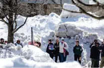  ?? WATCHARA PHOMICINDA VIA THE ASSOCIATED PRESS ?? Residents of San Bernardino Mountains brave long lines for food and supplies Friday at Goodwin & Son’s Market in Crestline, Calif., amidst a shortage caused by heavy snowfall and difficulti­es with delivery truck access to the area on Highway 18.