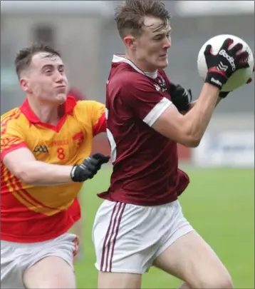  ??  ?? Joe O’Connor of St. Martin’s gets to the ball ahead of Conor Halligan (Sarsfields).