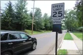  ?? DAN SOKIL — MEDIANEWS GROUP ?? A driver heads south on Line Street past a speed limit sign just south of the border between Lansdale and Hatfield Township on Tuesday.