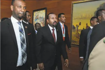  ?? Associated Press ?? Ethiopia’s Nobel Peace Prizewinni­ng Prime Minister Abiy Ahmed ( center) said, “The end is near” for the regional government of the country’s Tigray People’s Liberation Front.