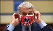  ?? AP PHOTO BY KEVIN DIETSCH/POOL ?? Dr. Anthony Fauci, director of the National Institute for Allergy and Infectious Diseases, adjusts his face mask during a House Subcommitt­ee on the Coronaviru­s crisis hearing, Friday, July 31, on Capitol Hill in Washington.