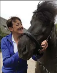  ?? ALEKSANDAR FURTULA — THE ASSOCIATED PRESS ?? Els van der Heijden, a cystic fibrosis patient, stands with her Icelandic horse in Hekendorp, Netherland­s on Thursday. Her condition improved with the help of tests done on mini organs generated from her own cells.