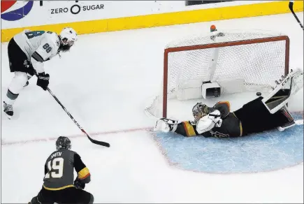  ?? John Locher ?? The Associated Press Sharks defenseman Brent Burns, left, scores against Golden Knights goaltender Marc-andre Fleury during the second period Saturday. The goal was upheld after the Knights had challenged the ruling.