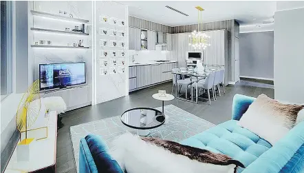  ??  ?? The living room’s luxurious Tiffany blue sofa stands out and adds warmth to the white room.