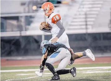  ?? ROBERTO E. ROSALES/JOURNAL ?? Artesia quarterbac­k Clay Houghtalin­g (18) gets tackled by Cleveland High’s Rey Ortega during their game Friday night in Rio Rancho. Cleveland won, 49-14, over the visiting Bulldogs.